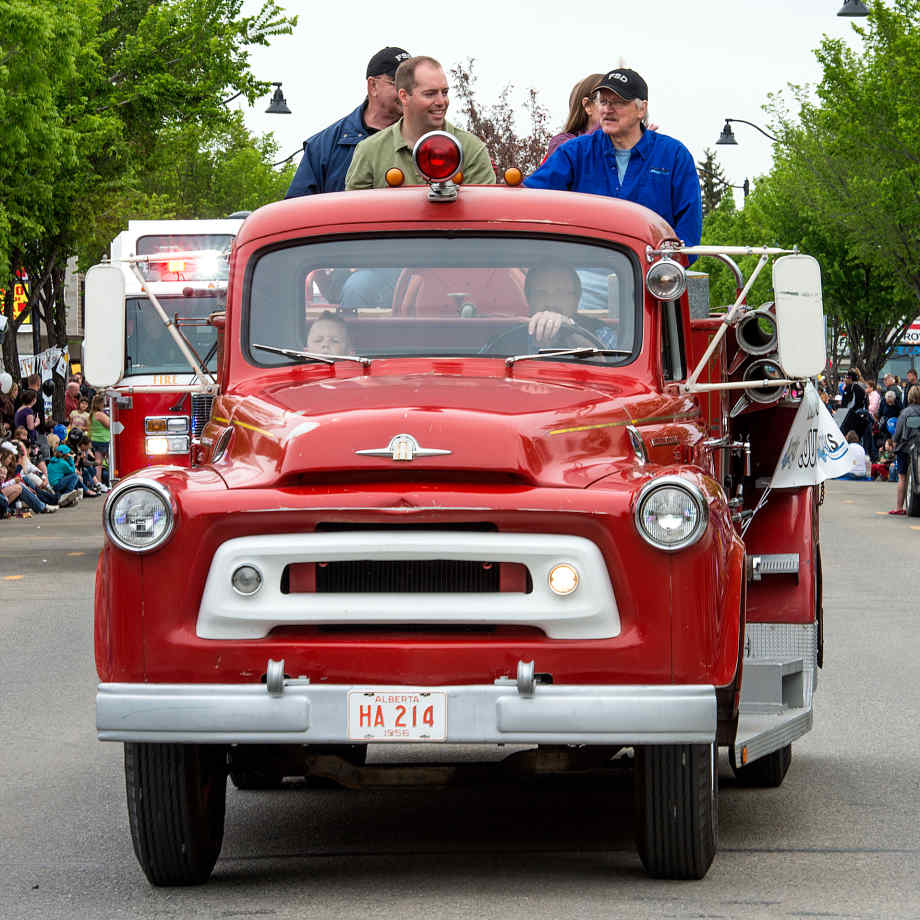 Mayor Robertson driving the old fire engine during the Okotoks Parade