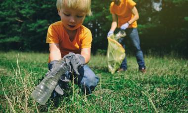 family-volunteers-with-children-collecting-garbage-park-save-environment-concept-little-boy-his-father-cleaning-up-forest