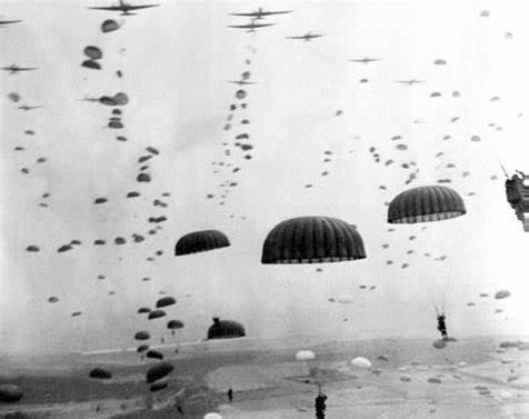 Photo of dozens of parachutes in the sky over Normandy on D-Day.