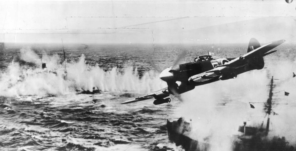 Photo of a bomber plane above water, taken from an airplane during the D-Day invasion.