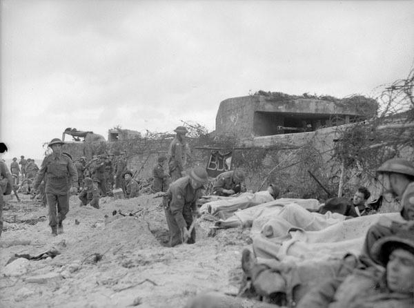 Wounded men lying on the beach.