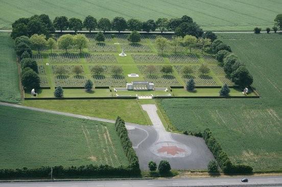 An aerial shot of a cemetery, surrounded by well-kept grass and trees.