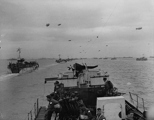 Photo of the front of a landing craft heading towards Normandy.