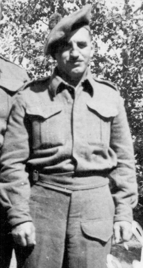 Black and white photo of a man wearing a World War Two army uniform.