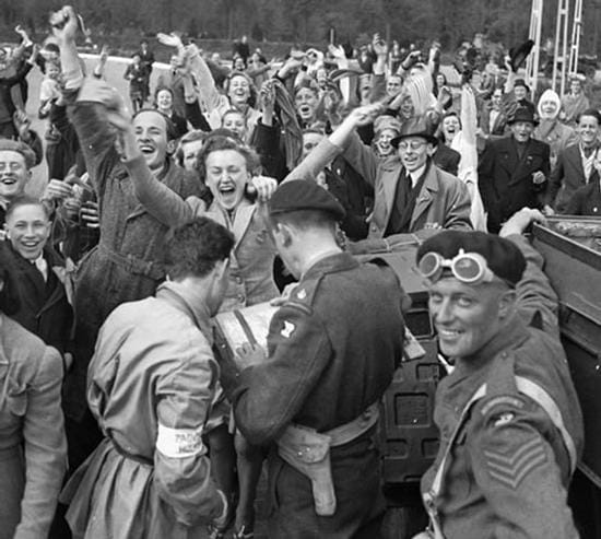 Black and white photo of Dutch civilians and soldiers celebrating the liberation of Utrecht, Netherlands, 1945.