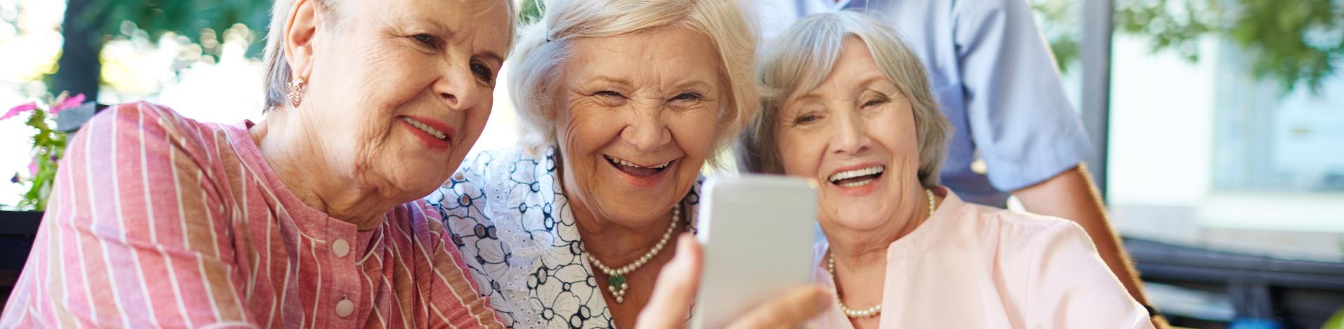 Group of smiling seniors take selfie photo