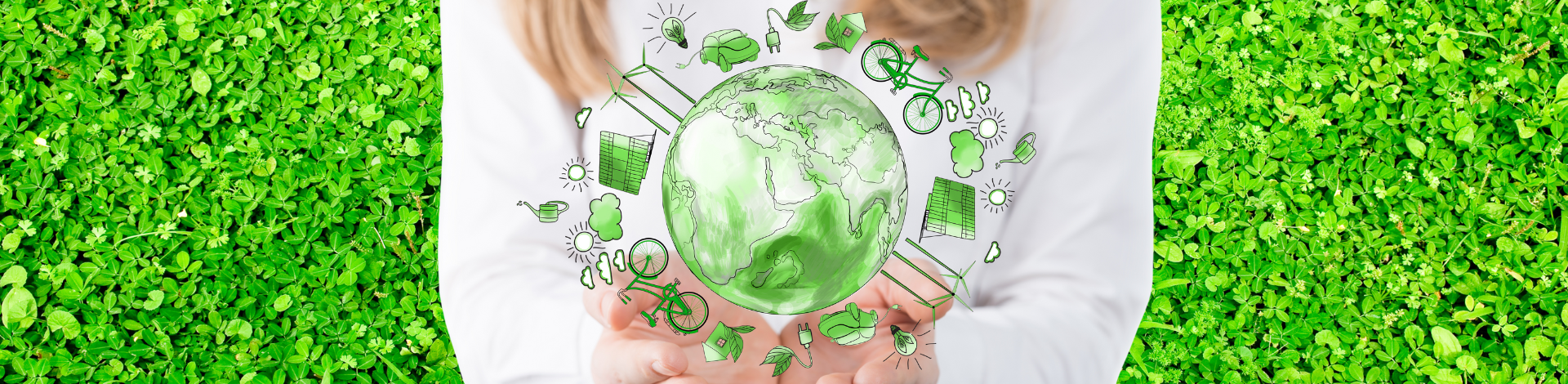 Hands holding illustration of globe surrounded by environment symbols