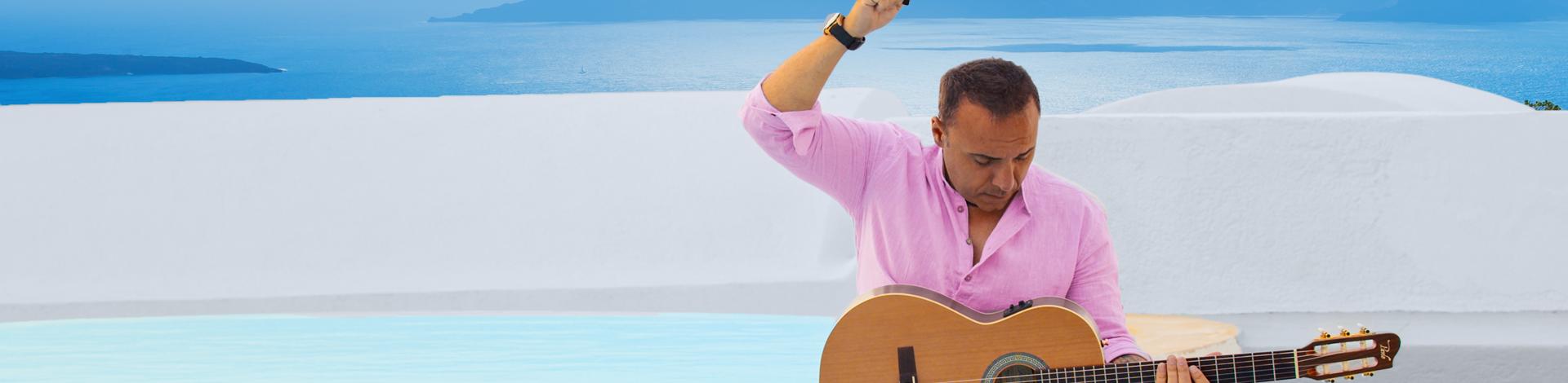 the artist PAVLO in a pool with his guitar