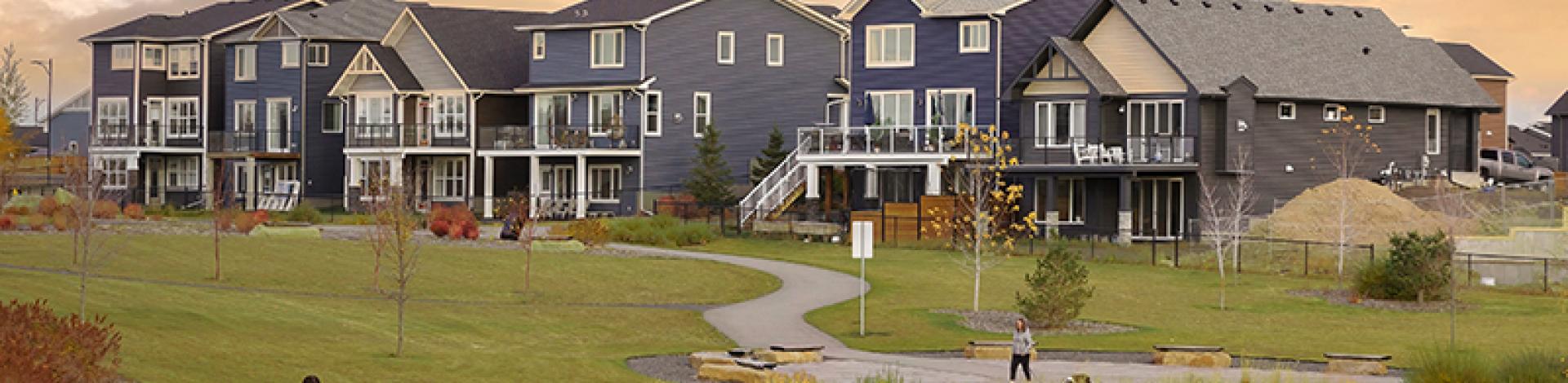 a nice shot of some houses and a walking path in okotoks