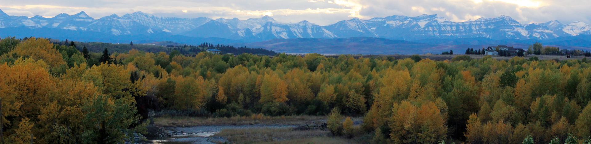 Okotoks river and mountain shot in fall 