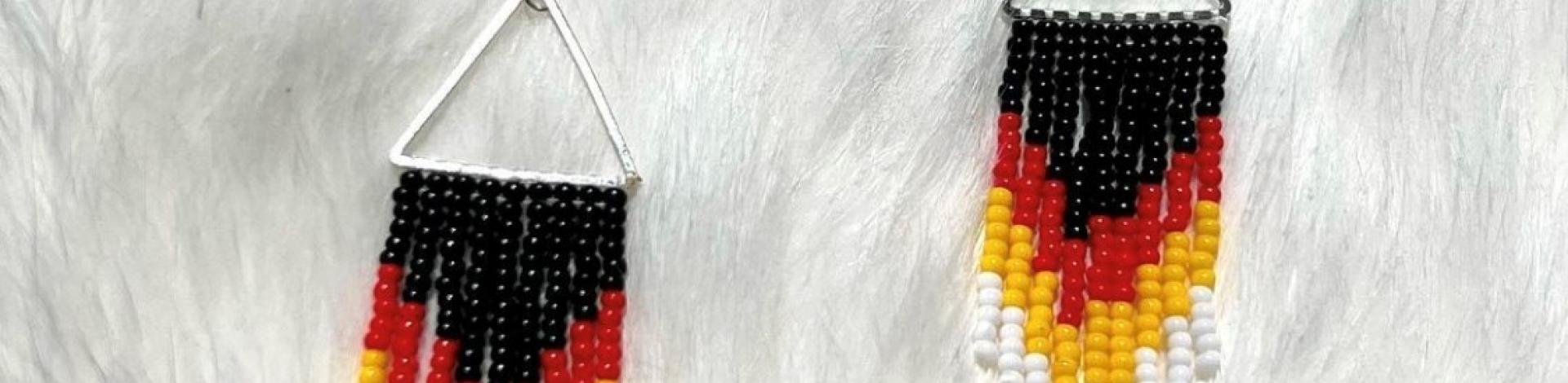 Black, red, yellow, and white beaded earrings.