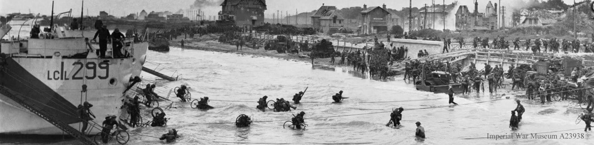 Black and white photo of men wading ashore on D-Day.