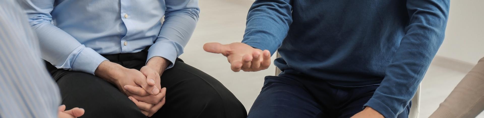 a group of men sit in a circle 