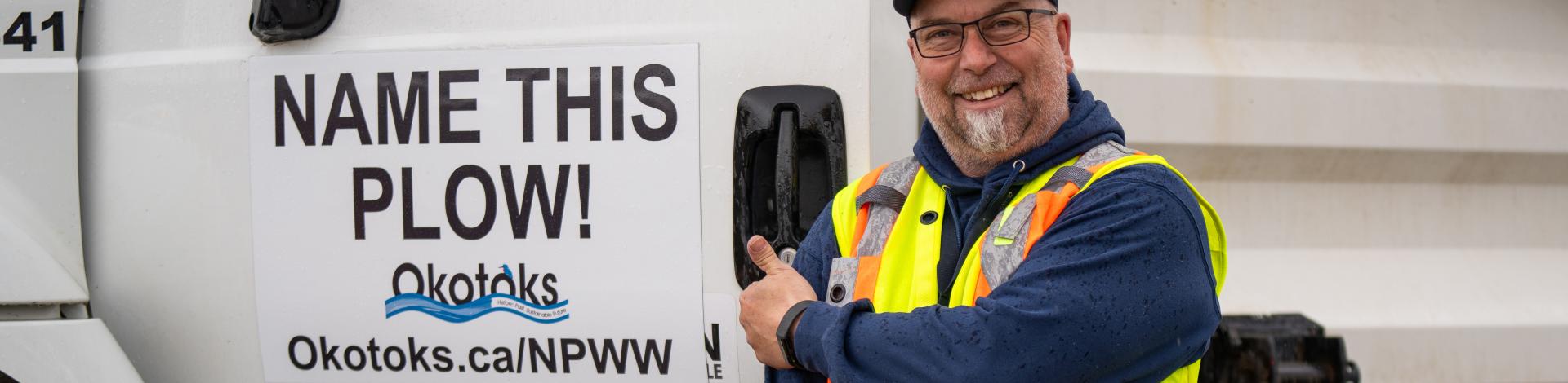 Smiling transportation driver with snow plow