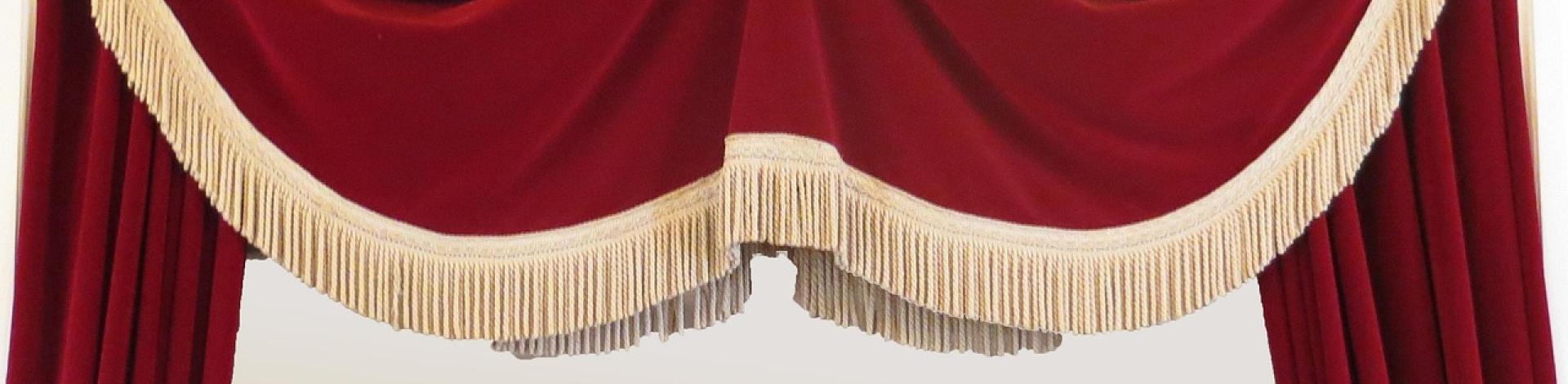 A red curtain over a theatre stage.