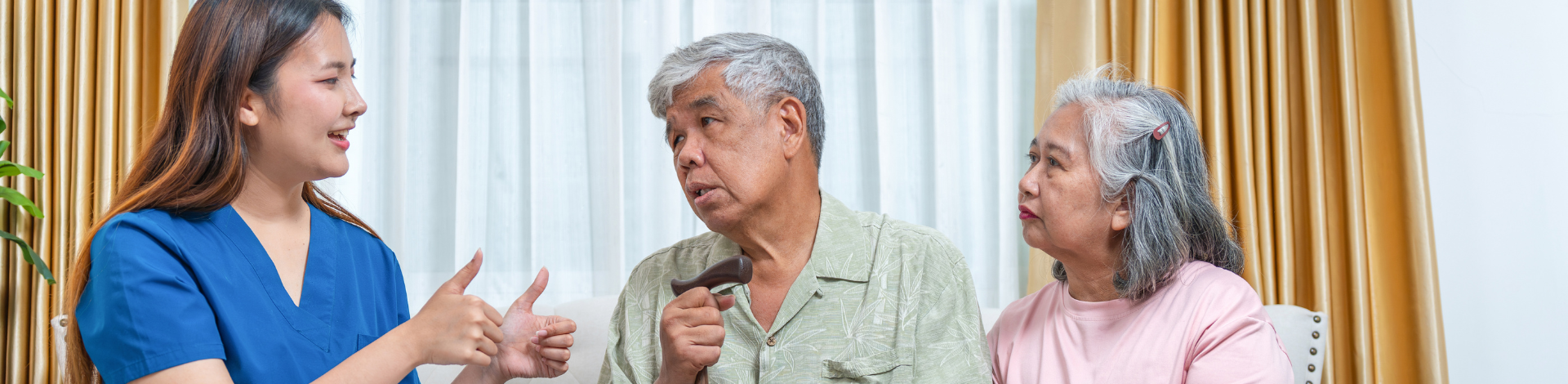 A health practitioner speaks to two seniors