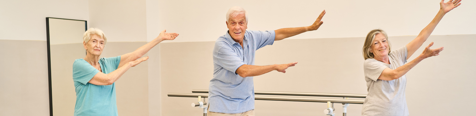 three seniors are seen swinging their arms, exercising 