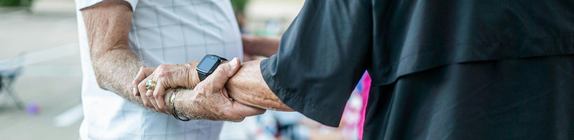 two seniors hold arms together