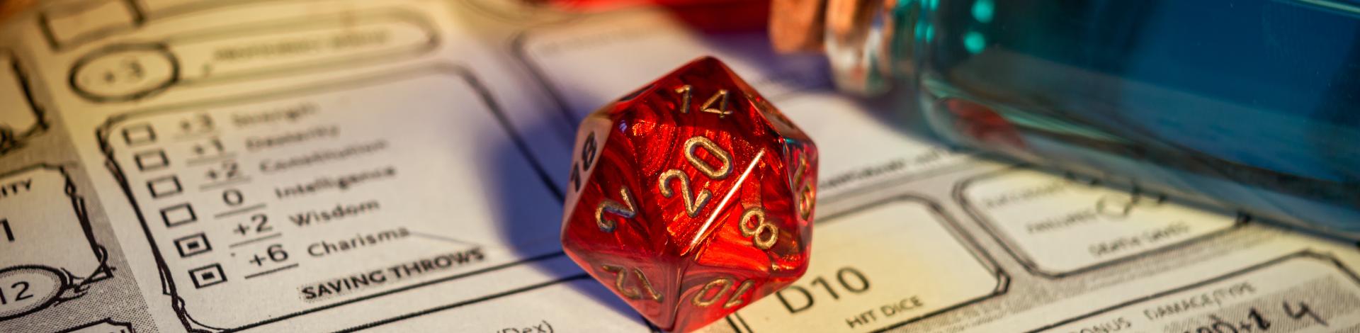 Close-up of a red d20 on a character sheet