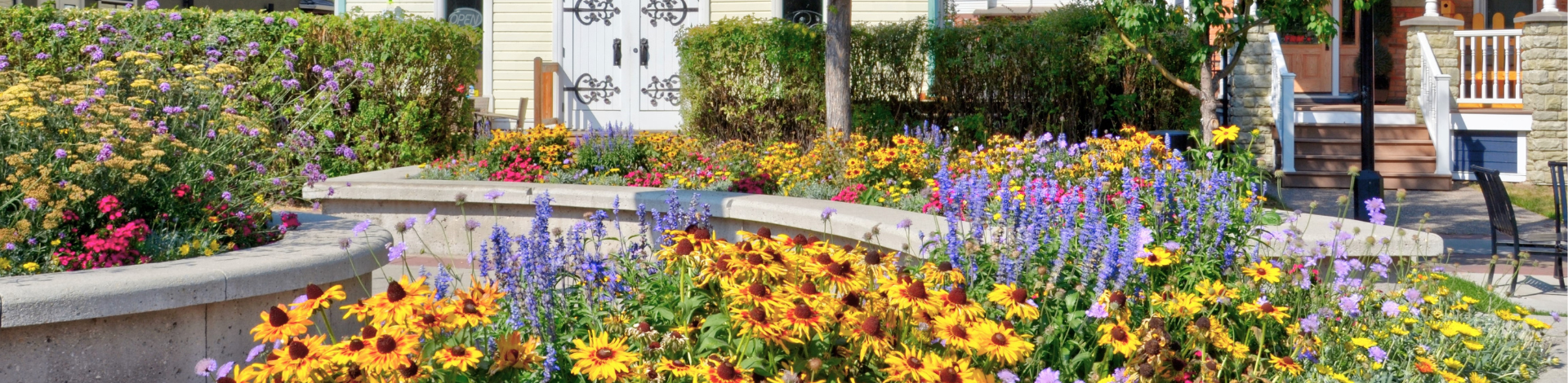 A planter full of flower blooms in downtown okotoks