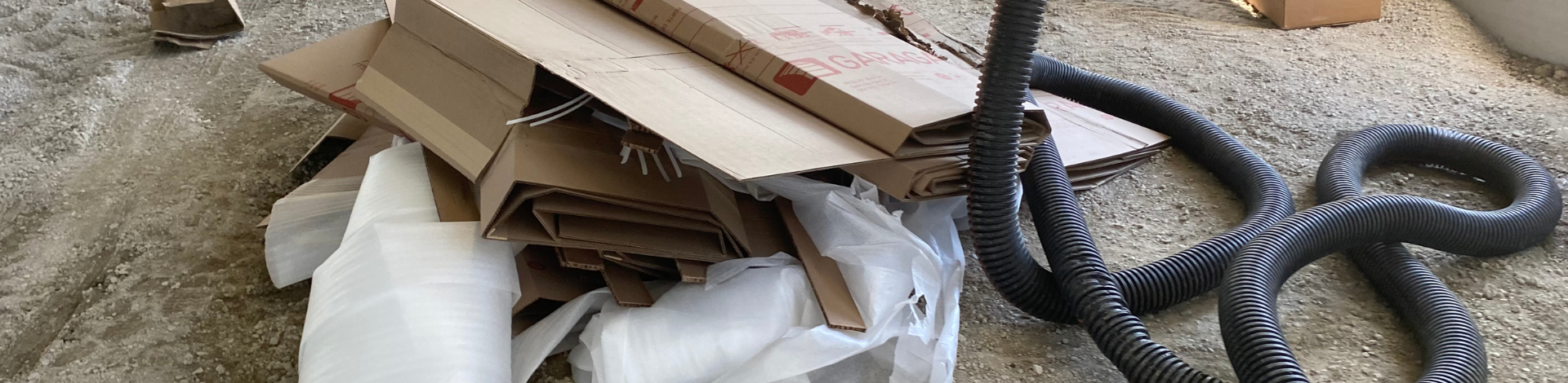 construction materials and trash lay in a pile