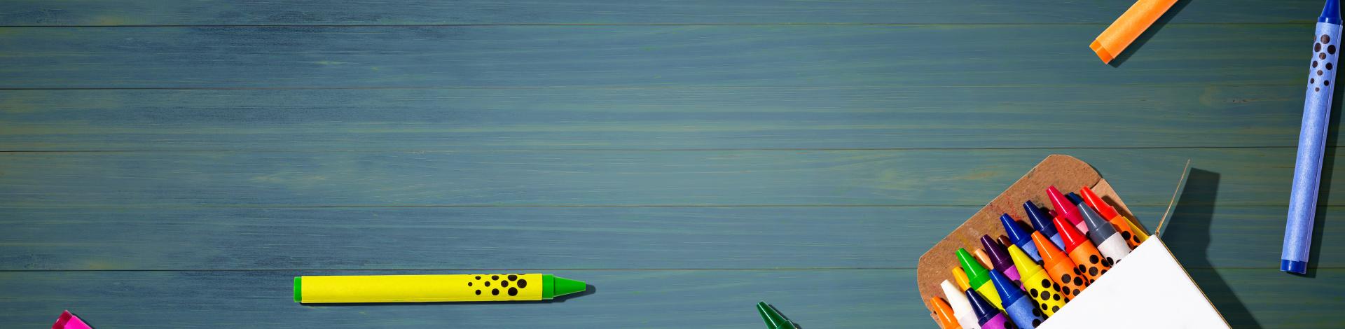 Colorful wax crayons with a box