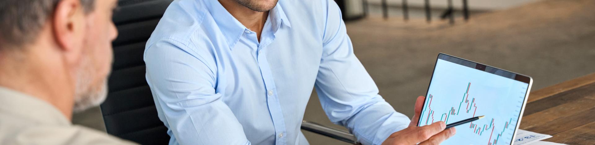 Two busy business men analysts doing finance on laptop