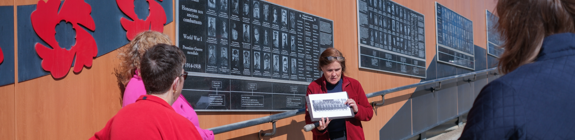 Staff point to a wall of vetrans who died in WW1