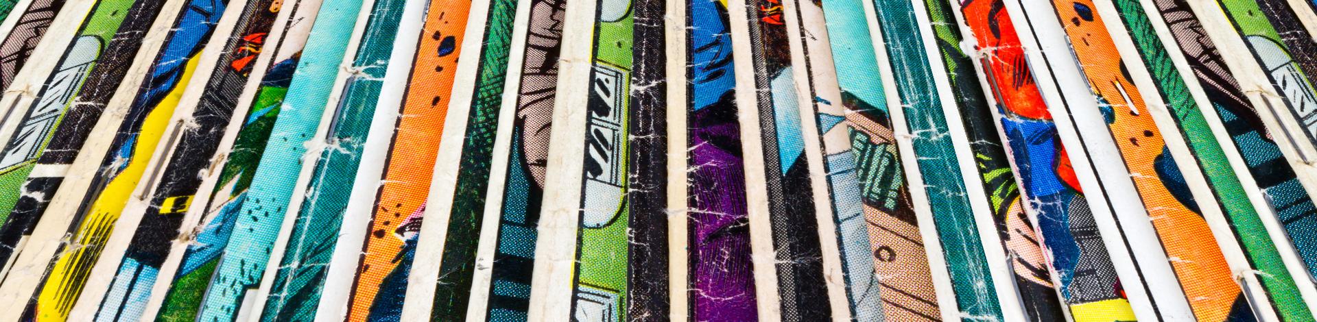Stack of old comic books creates colorful background texture