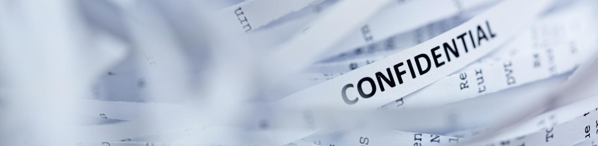 shredded documents with the word confidential on it