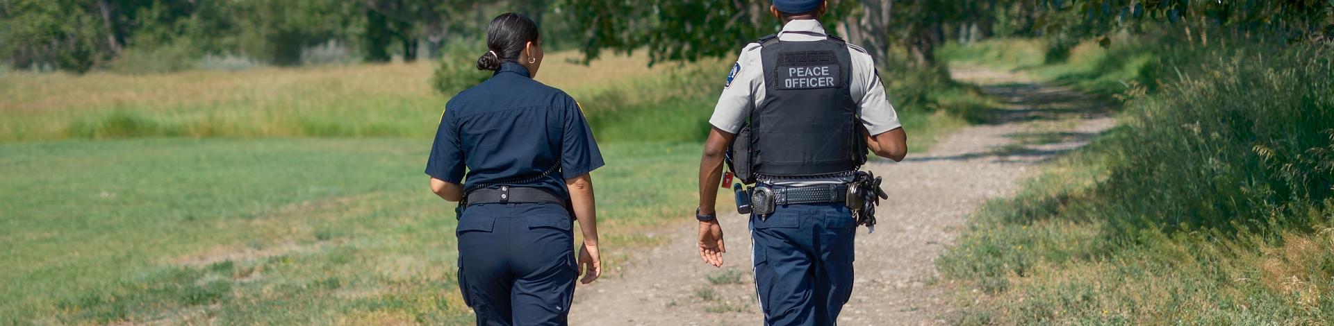 Two peace officers walking in park