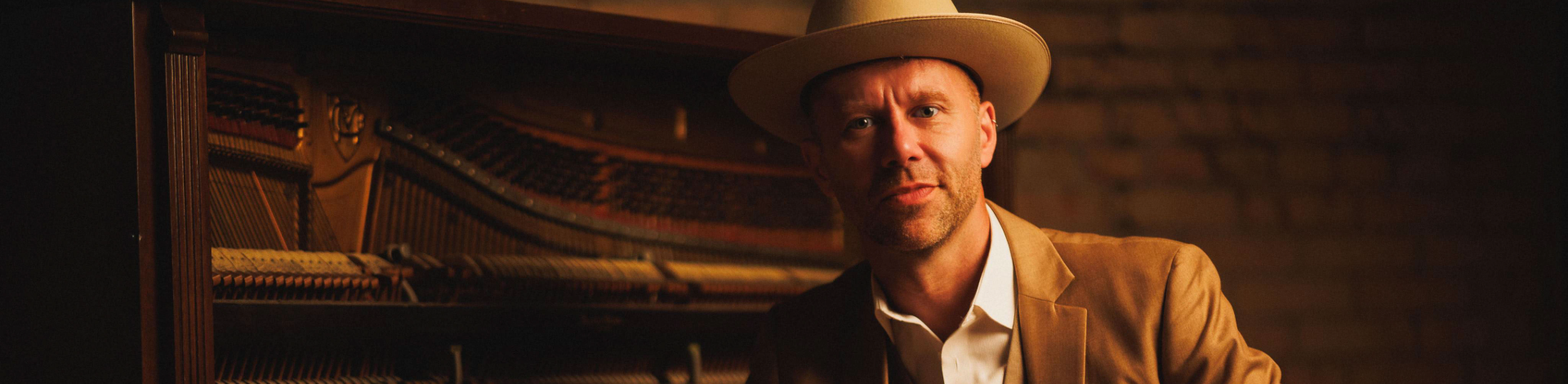 Jeffery Straker in front of a piano