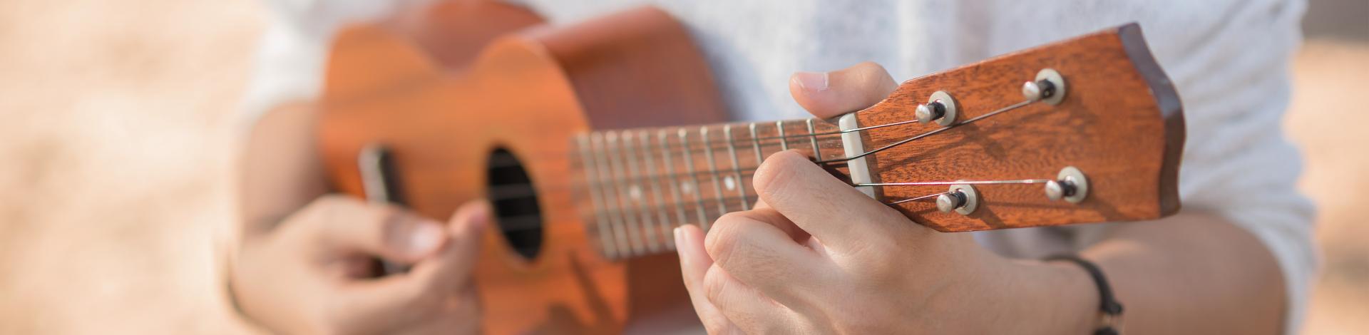 Young woman playing on Ukulele