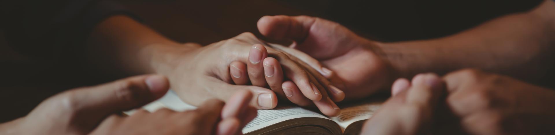 Holding hands over a book