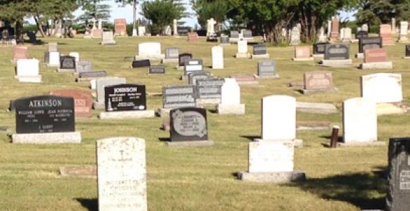 A photo of gravestones in a cemetery.
