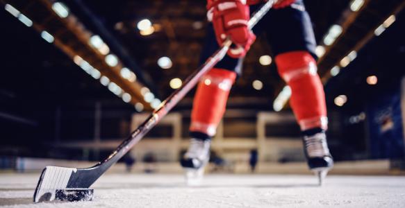 close-up-hockey-player-skating-with-stick-puck