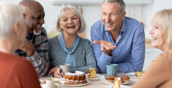 Group of seniors enjoying coffee and snacks