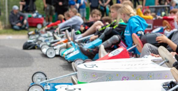 kids in soapbox carts line up for a photo