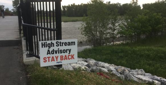 High Streamflow Advisory Sign posted by Sheep River bridge