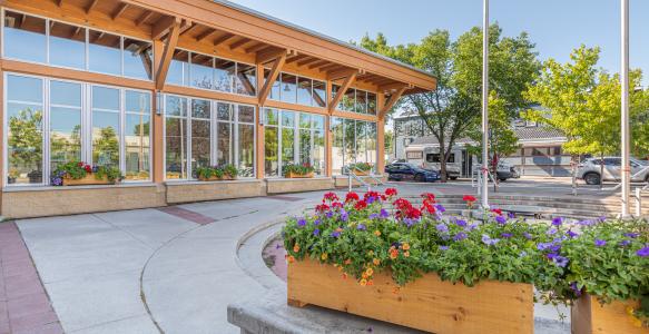Okotoks Municipal Centre in summer with flowers blooming out front