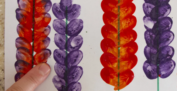 Purple and red snapdragons made with fingerpaint.