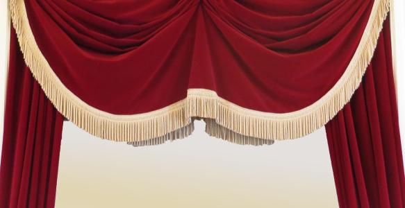 A red curtain over a theatre stage.