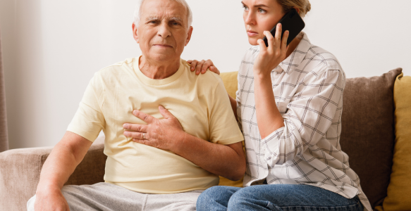 woman calls someone while supporting older male adult 