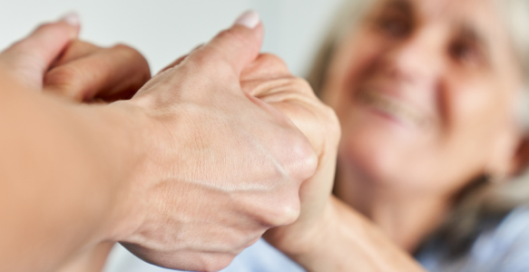 supportive hand holding seniors 