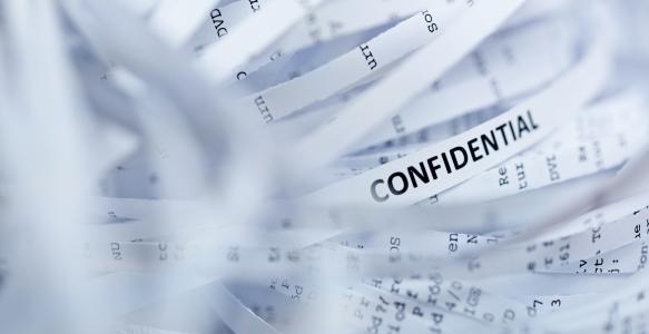 shredded documents with the word confidential on it