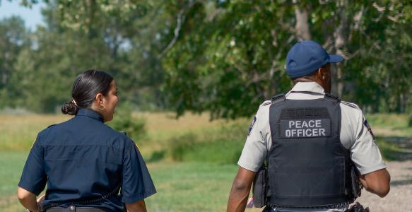 two peace officers walking in park