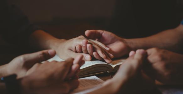 Holding hands over a book