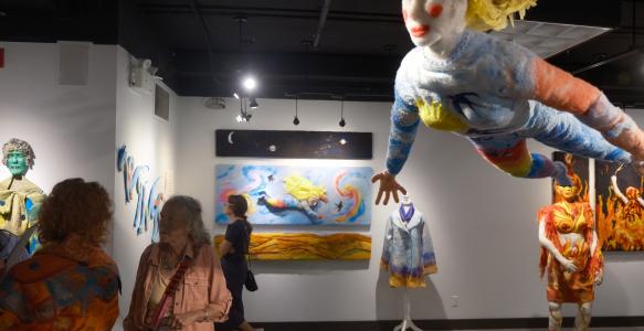 an art gallery with lifesized artwork