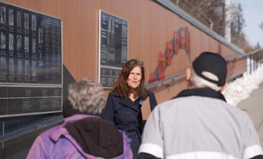 Kathy Coutts of the Museum walks with visiters on vetrans way