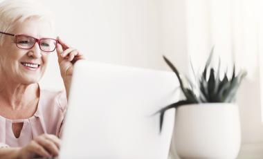 older adult lady working on her laptop